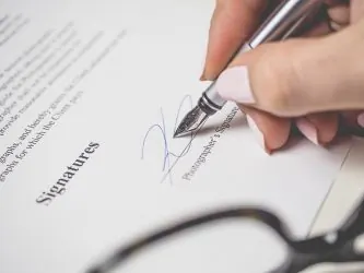 Pen signing a document